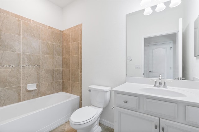 full bathroom featuring tile patterned flooring, tiled shower / bath, vanity, and toilet