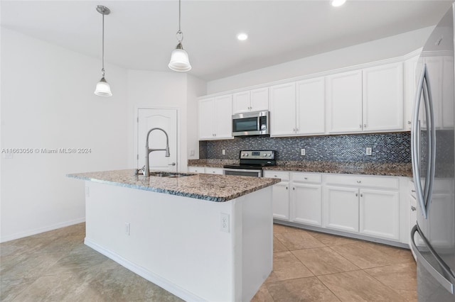 kitchen featuring white cabinets, a center island with sink, appliances with stainless steel finishes, and pendant lighting