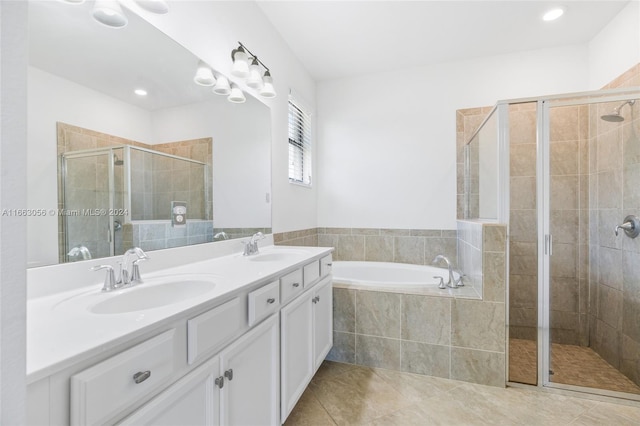 bathroom featuring vanity, plus walk in shower, and tile patterned flooring