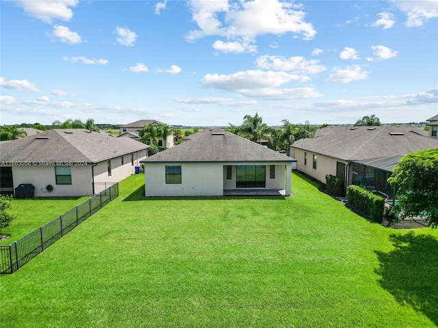 rear view of house with a lawn