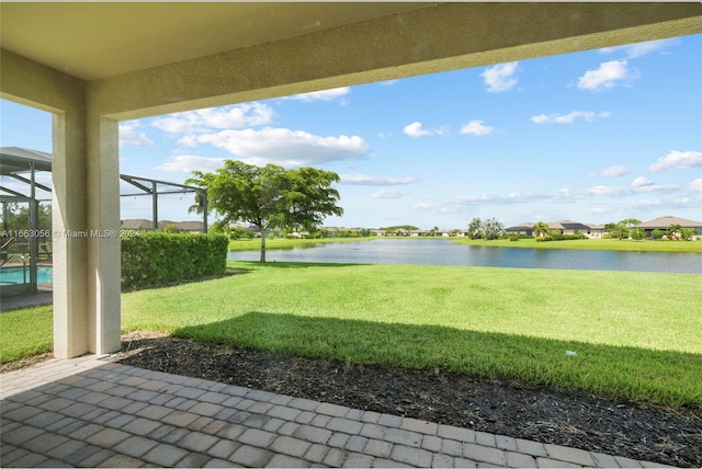 view of yard with a water view and a lanai