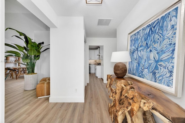 hall with light hardwood / wood-style floors