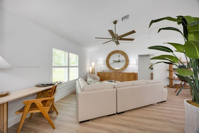 living room featuring light wood-type flooring, lofted ceiling, and ceiling fan