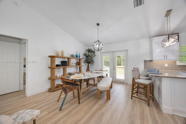 dining room with lofted ceiling and light hardwood / wood-style floors