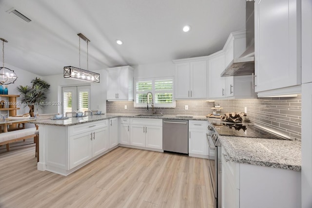 kitchen with pendant lighting, white cabinets, appliances with stainless steel finishes, and a healthy amount of sunlight