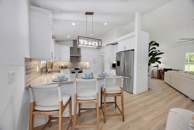 kitchen featuring light hardwood / wood-style floors, tasteful backsplash, white cabinets, stainless steel appliances, and sink