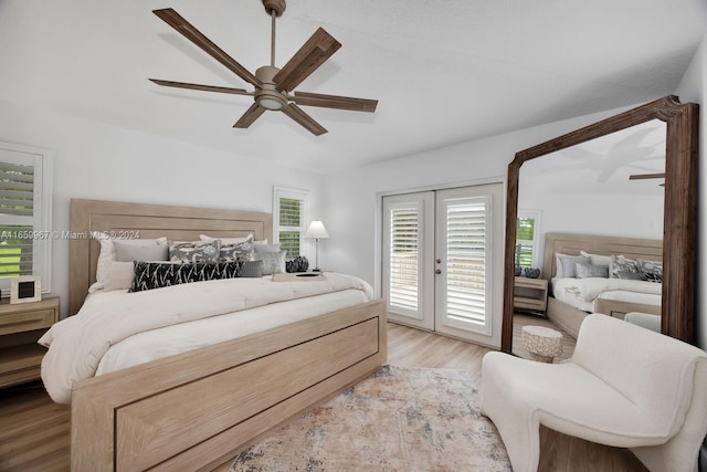 bedroom with access to outside, light wood-type flooring, french doors, and ceiling fan