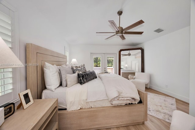 bedroom featuring ceiling fan, light hardwood / wood-style flooring, french doors, and access to outside