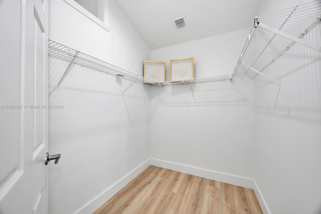 walk in closet featuring hardwood / wood-style flooring