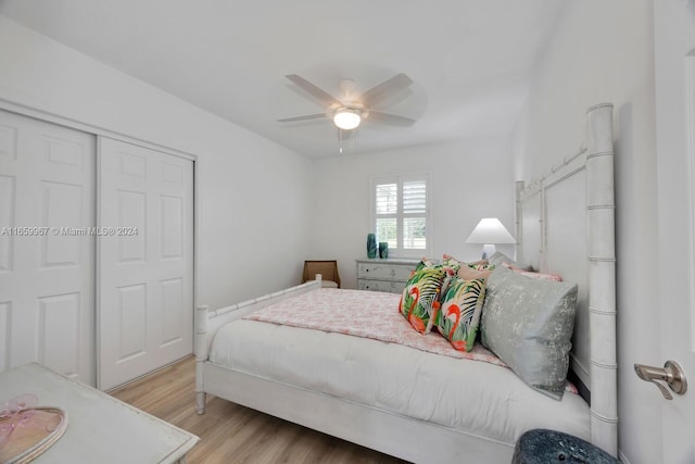 bedroom with ceiling fan, a closet, and light hardwood / wood-style floors