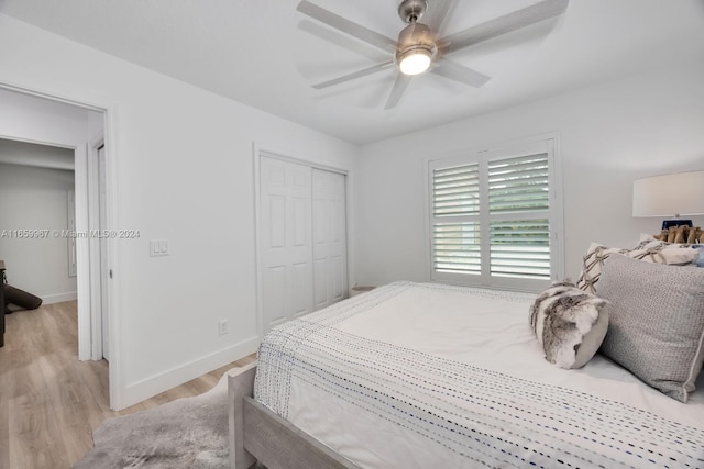 bedroom featuring ceiling fan, a closet, and light hardwood / wood-style floors