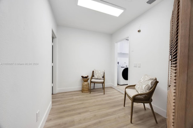 living area featuring light hardwood / wood-style floors and washer / clothes dryer