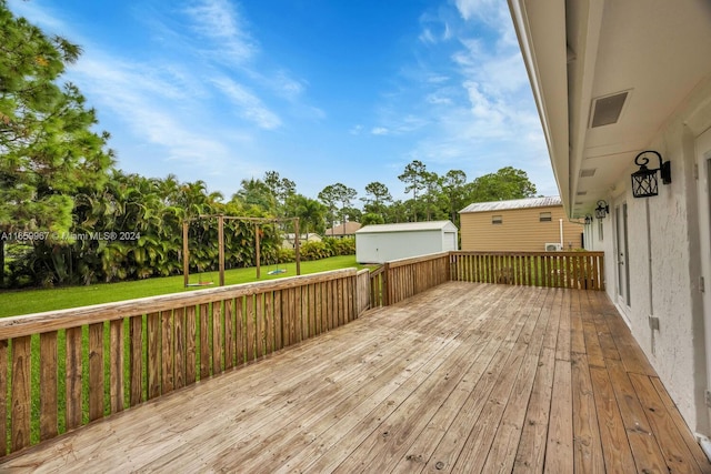 wooden terrace featuring a yard