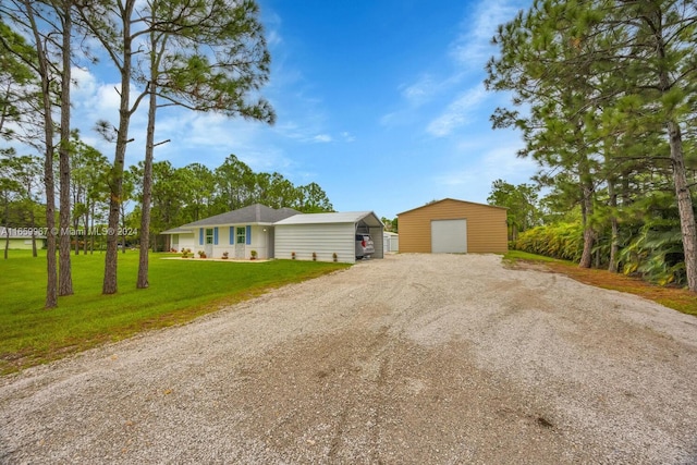 ranch-style home with an outdoor structure, a garage, and a front lawn