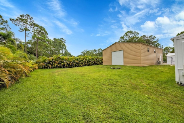 view of yard featuring an outdoor structure and a garage