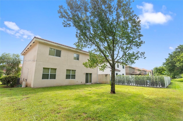 back of property featuring a lawn