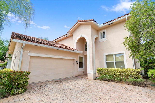 mediterranean / spanish-style home featuring a garage