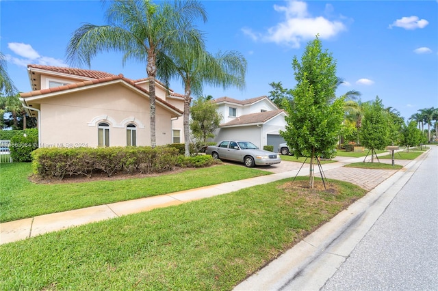 view of front facade with a garage and a front yard