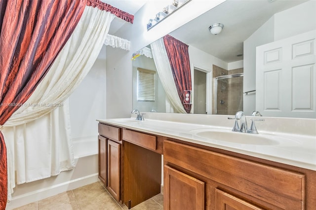 bathroom featuring tile patterned flooring, vanity, and bath / shower combo with glass door