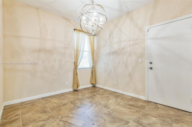 empty room featuring a chandelier