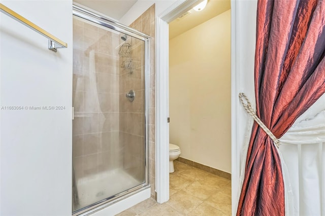 bathroom with walk in shower, tile patterned flooring, and toilet