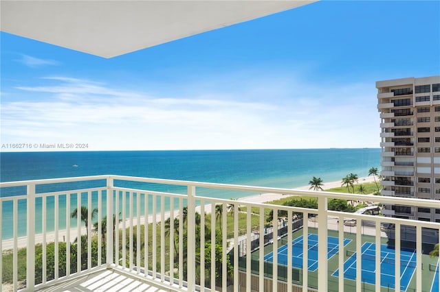 balcony featuring a beach view and a water view