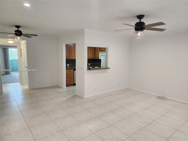 spare room with light tile patterned floors, a textured ceiling, ceiling fan, and crown molding