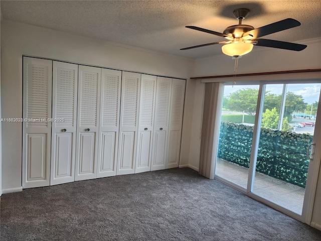 unfurnished bedroom with access to exterior, ceiling fan, carpet flooring, and a textured ceiling