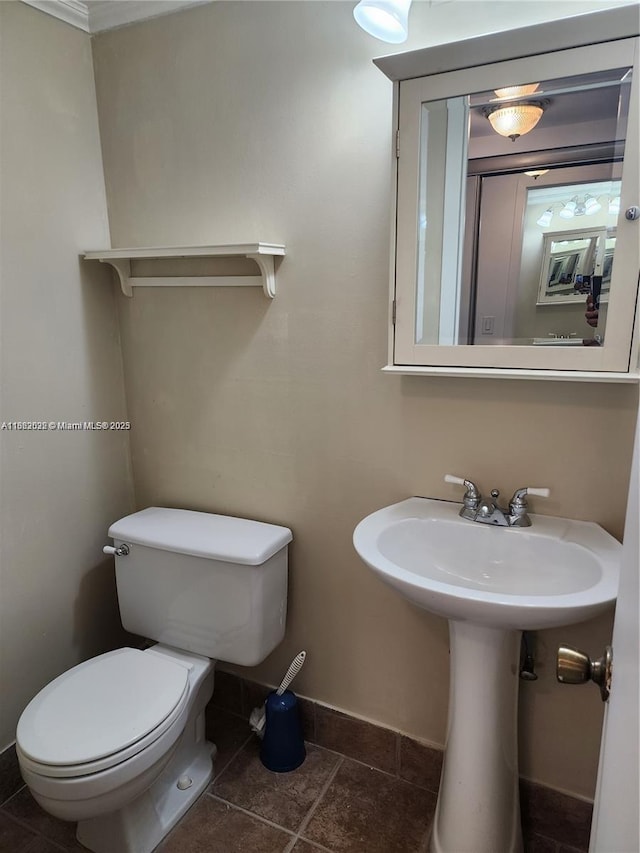 bathroom with tile patterned flooring and toilet