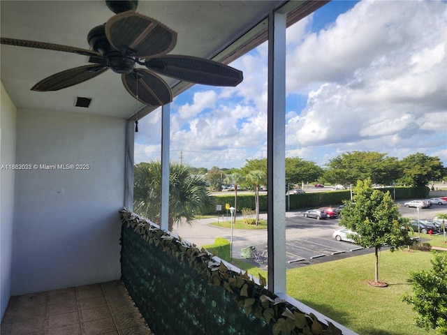 sunroom / solarium featuring plenty of natural light and ceiling fan