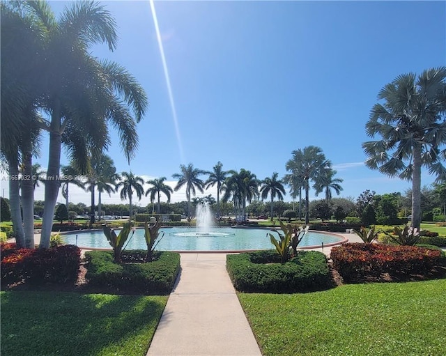 surrounding community featuring a lawn and a water view