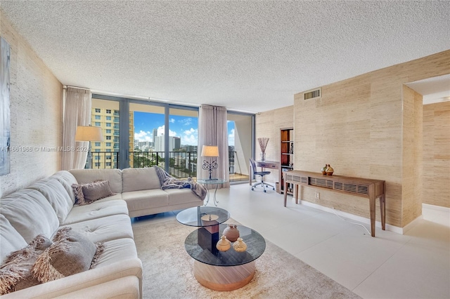 living room featuring a textured ceiling and expansive windows