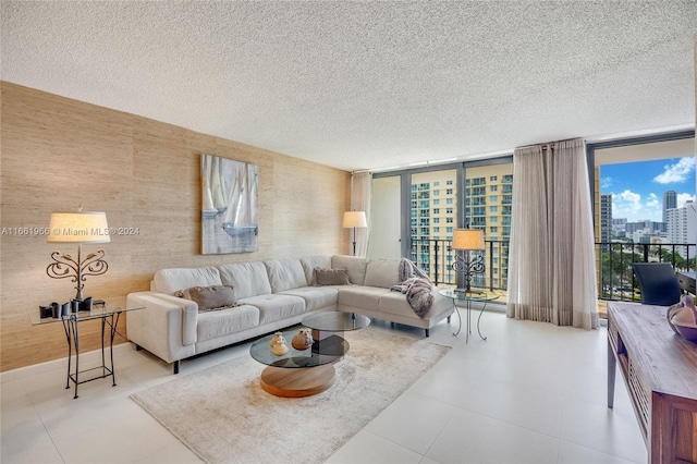 living room featuring floor to ceiling windows and a textured ceiling