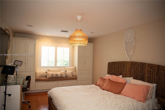 bedroom with dark wood-type flooring