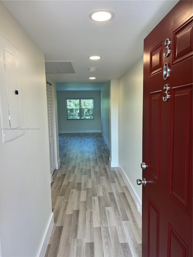 hallway with light hardwood / wood-style floors