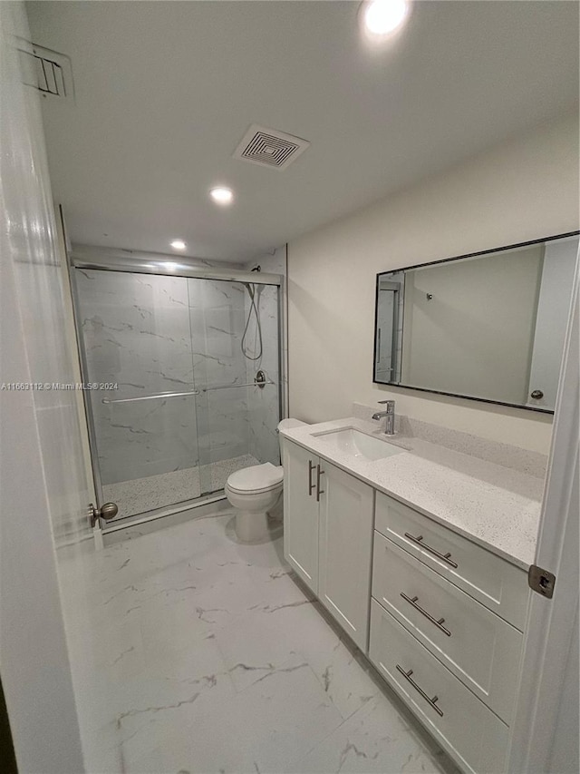 bathroom with vanity, toilet, and walk in shower