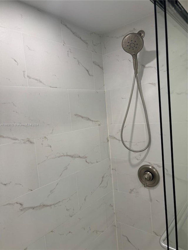 interior details featuring tiled shower