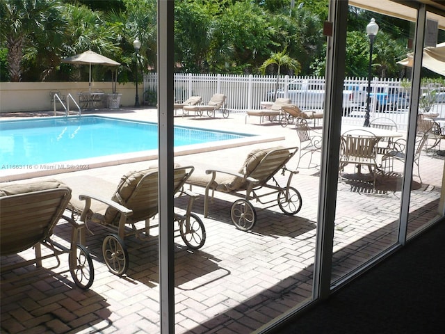 view of swimming pool with a patio