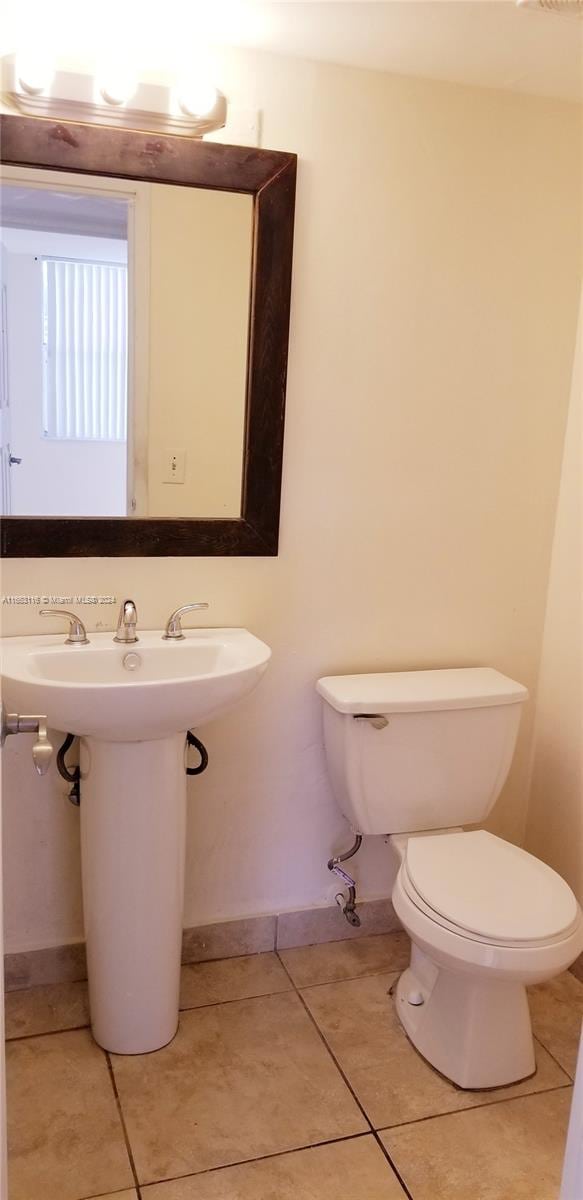 bathroom featuring tile patterned flooring and toilet