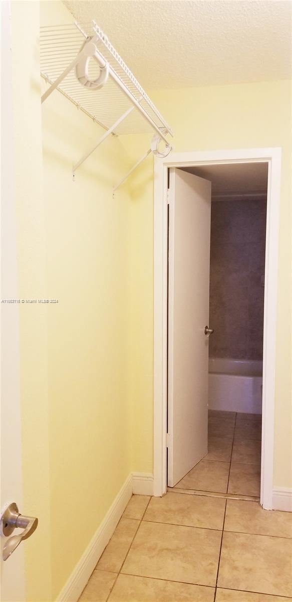 walk in closet featuring tile patterned flooring