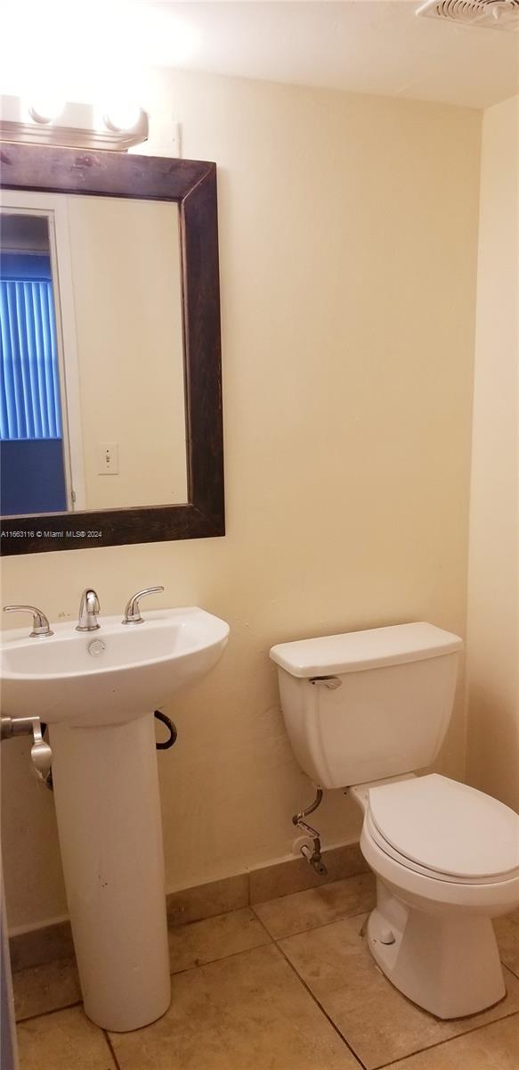 bathroom featuring tile patterned flooring, sink, and toilet