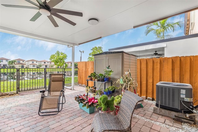 view of patio with ceiling fan and a water view