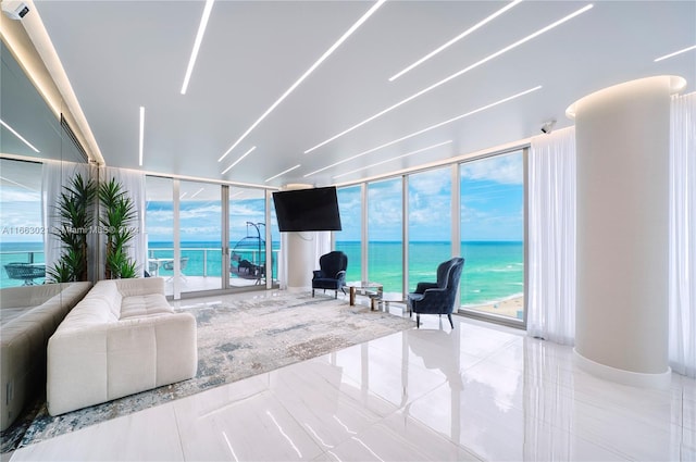 living room with light tile patterned flooring and plenty of natural light