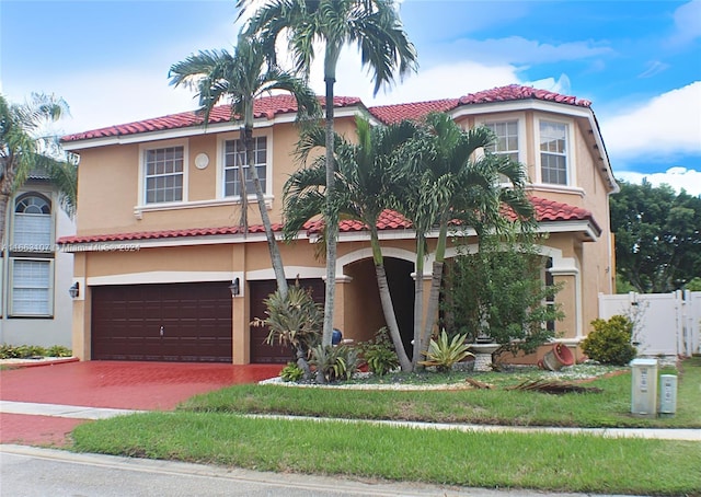 mediterranean / spanish house with a front lawn and a garage