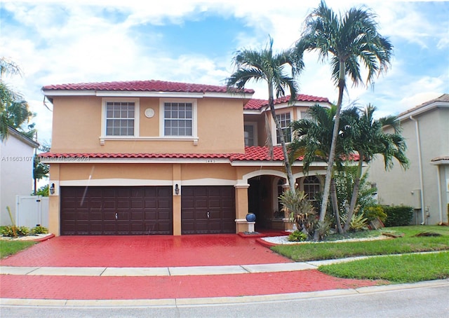 mediterranean / spanish house with a garage