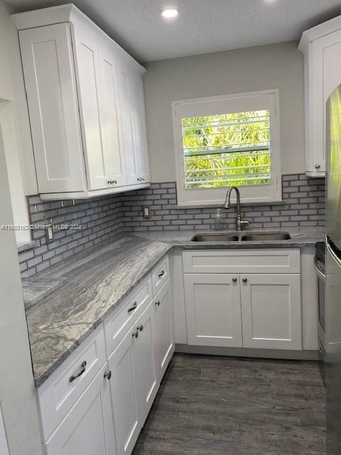 kitchen with sink, dark hardwood / wood-style flooring, and white cabinets