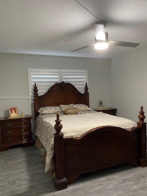 bedroom featuring hardwood / wood-style floors and ceiling fan