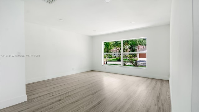 spare room with light hardwood / wood-style floors