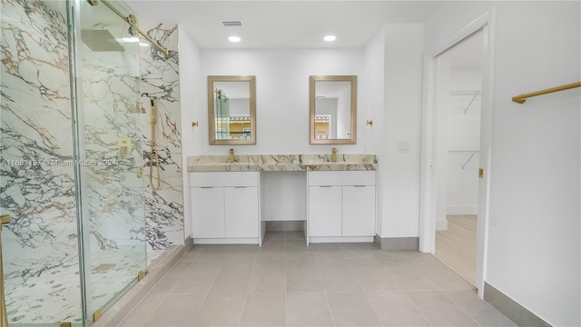 bathroom featuring vanity, an enclosed shower, and tile patterned floors