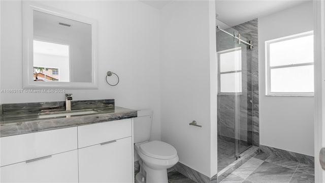 bathroom featuring walk in shower, vanity, toilet, and plenty of natural light